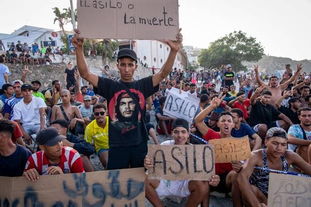 August 17, 2026, Ceuta, Spain: CEUTA, SPAIN Ã¢â‚¬ AUGUST 17, 2026: More than 100 migrants, most of them Moroccan, have been protesting for days in front of National Police vans during the daily food distribution provided by the Spanish Red Cross at TrampoloÂ­n Beach. Ã¢â‚¬oeNo asylum, no foodÃ¢â‚¬Â is the chant repeated by the migrants on the sand, while African migrants continue to stay in the temporary accommodation facilities set up on the Ceuta beach. Authorities are expected to clear the beach in the coming days and transfer the migrants to four reception facilities announced today by SpainÃ¢â‚¬â ¢s Minister for Migration, Elma Saiz. Ceuta Spain - ZUMAq101 20260817_zna_q101_083 Copyright: xAntonioxSemperex