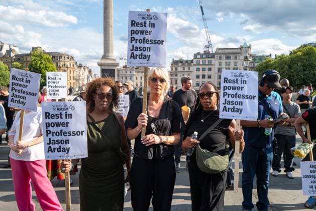 August 17, 2026, London, United Kingdom: Three mourners pose with signs at the vigil for Professor Jason Arday in Trafalgar Square..A vigil was organised by the campaign group Stand Up to Racism, after Professor Jason Arday was found dead at his home. He had resigned from his position as professor of sociology of education at Cambridge, amid accusations of plagiarism, which he denied. London United Kingdom - ZUMAs197 20260817_aaa_s197_110 Copyright: xPhilxLewisx