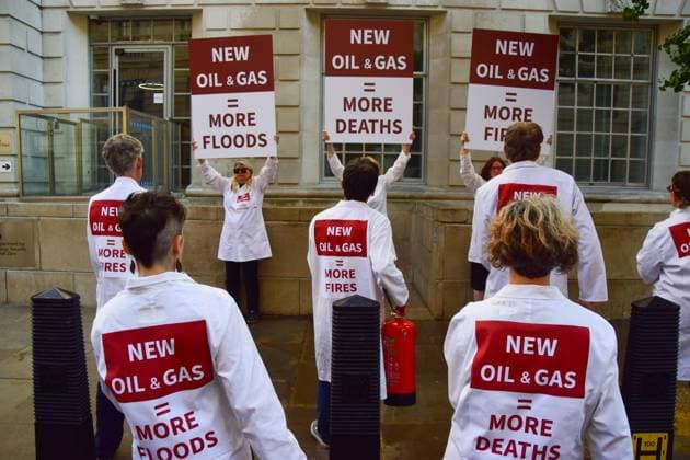 Anti-Rosebank Protests in London, UK - 17 Aug 2026 Climate activists from the group Scientists On Survival wearing lab coats stand with placards and fire extinguishers after spraying the building with water during a protest against Rosebank outside the Department for Energy Security and Net Zero (DESNZ). Two separate groups staged protests in Westminster as the public consultation on the North Sea oil and gas field concludes. London United Kingdom Copyright: xVukxValcicx xSOPAxImagesx Vuk-Valcic-1442821