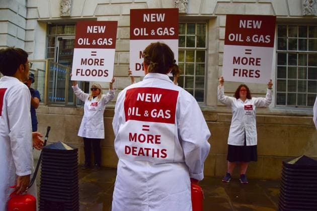 Anti-Rosebank Protests in London, UK - 17 Aug 2026 Climate activists from the group Scientists On Survival wearing lab coats stand with placards and fire extinguishers after spraying the building with water during a protest against Rosebank outside the Department for Energy Security and Net Zero (DESNZ). Two separate groups staged protests in Westminster as the public consultation on the North Sea oil and gas field concludes. London United Kingdom Copyright: xVukxValcicx xSOPAxImagesx Vuk-Valcic-1442824