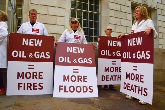 Anti-Rosebank Protests in London, UK - 17 Aug 2026 Climate activists from the group Scientists On Survival wearing lab coats stand with anti-fossil fuel placards during a protest against Rosebank outside the Department for Energy Security and Net Zero (DESNZ). Two separate groups staged protests in Westminster as the public consultation on the North Sea oil and gas field concludes. London United Kingdom Copyright: xVukxValcicx xSOPAxImagesx Vuk-Valcic-1442828