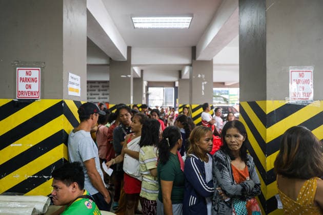 Tens of thousands evacuated in Philippines amid monsoon rains, floods QUEZON CITY, PHILIPPINES - AUGUST 18: People evacuated from flooded areas wait in queue to collect food and supplies at a secondary school-turned emergency shelter, amid lingering threats of flooding caused by heavy monsoon rains, in Quezon City, Metro Manila, Philippines, on August 18, 2026. As the country remains threatened by floods caused by monsoon heavy rains, tens of thousands of people in the capital region of Metro Manila and its surrounding cities and areas have been evacuated, with schools in multiple locations across the Philippines being suspended for safety reasons. Daniel Ceng Anadolu Quezon City Philippines. Editorial use only. Please get in touch for an  Copyright: x2026xAnadoluxDanielxCengx