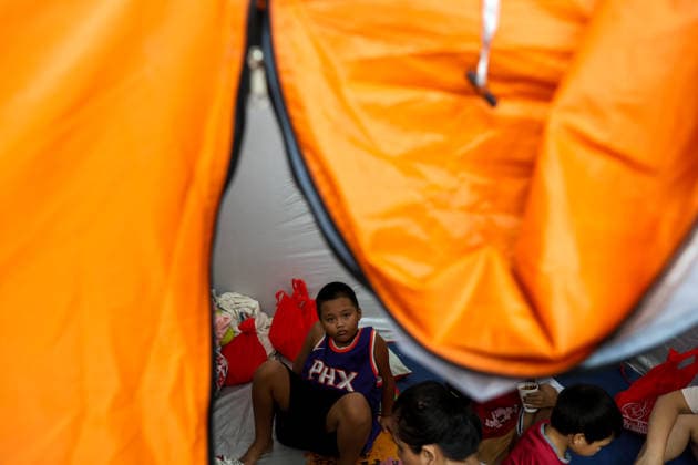Tens of thousands evacuated in Philippines amid monsoon rains, floods QUEZON CITY, PHILIPPINES - AUGUST 18: People evacuated from flooded areas take shelter at a secondary school basketball court, amid lingering threats of flooding caused by heavy monsoon rains, in Quezon City, Metro Manila, Philippines, on August 18, 2026. As the country remains threatened by floods caused by monsoon heavy rains, tens of thousands of people in the capital region of Metro Manila and its surrounding cities and areas have been evacuated, with schools in multiple locations across the Philippines being suspended for safety reasons. Daniel Ceng Anadolu Quezon City Philippines. Editorial use only. Please get in touch for any other usage.  Copyright: x2026xAnadoluxDanielxCengx