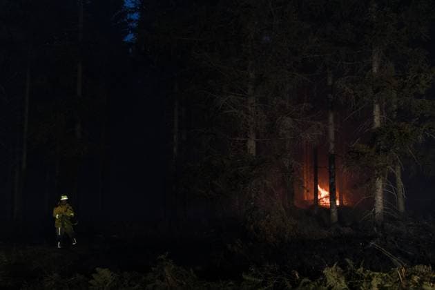 Firefighters pictured in action, as a fire rages in the Hautes Fagnes (High Fens) nature reserve, on Tuesday 18 August 2026. The fire started on August 14th and 2700 hectares (on a total of 4500) are impacted.  NICOLASxLAMBERT 183633705