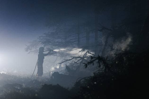 Firefighters pictured in action, as a fire rages in the Hautes Fagnes (High Fens) nature reserve, on Tuesday 18 August 2026. The fire started on August 14th and 2700 hectares (on a total of 4500) are impacted.  NICOLASxLAMBERT 183633754