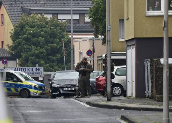 Police seal off Erlenhofstrasse in Cologne after reports of gunshots from attic COLOGNE, GERMANY - AUGUST 18: German police officers secure the cordoned-off perimeter around Erlenhofstrasse during an ongoing armed operation in the Niehl district of Cologne, Germany, on August 18, 2026. Following reports that a man fired gunshots into the air from an attic apartment, numerous police units were dispatched to the scene, shutting down Erlenhofstrasse and surrounding connecting roads to vehicular and pedestrian traffic while urging the public to avoid the area. Kadir Ilboga Anadolu Cologne Germany. Editorial use only. Please get in touch for any other usage.  Copyright: x2026xAnadoluxKadirxIlbogax