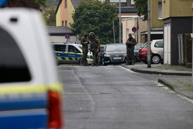 Police seal off Erlenhofstrasse in Cologne after reports of gunshots from attic COLOGNE, GERMANY - AUGUST 18: German police officers secure the cordoned-off perimeter around Erlenhofstrasse during an ongoing armed operation in the Niehl district of Cologne, Germany, on August 18, 2026. Following reports that a man fired gunshots into the air from an attic apartment, numerous police units were dispatched to the scene, shutting down Erlenhofstrasse and surrounding connecting roads to vehicular and pedestrian traffic while urging the public to avoid the area. Kadir Ilboga Anadolu Cologne Germany. Editorial use only. Please get in touch for any other usage.  Copyright: x2026xAnadoluxKadirxIlbogax