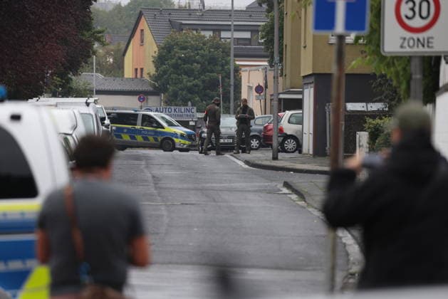 Police seal off Erlenhofstrasse in Cologne after reports of gunshots from attic COLOGNE, GERMANY - AUGUST 18: German police officers secure the cordoned-off perimeter around Erlenhofstrasse during an ongoing armed operation in the Niehl district of Cologne, Germany, on August 18, 2026. Following reports that a man fired gunshots into the air from an attic apartment, numerous police units were dispatched to the scene, shutting down Erlenhofstrasse and surrounding connecting roads to vehicular and pedestrian traffic while urging the public to avoid the area. Kadir Ilboga Anadolu Cologne Germany. Editorial use only. Please get in touch for any other usage.  Copyright: x2026xAnadoluxKadirxIlbogax