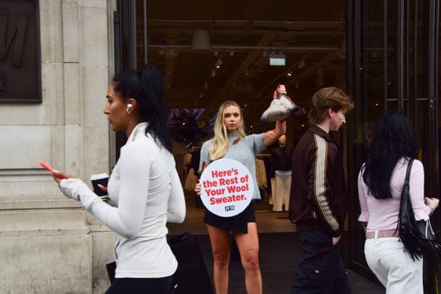 August 18, 2026, London, England, United Kingdom: People walk past a PETA activist wearing a faux wool top covered in fake blood and holding an artificial severed sheep s head and a placard reading Here s the Rest of Your Wool Sweater outside the H&M store on Regent Street. The action is part of the animal rights group s ongoing campaign calling on H&M to stop selling wool products. London United Kingdom  - ZUMAv130 20260818_zip_v130_033 Copyright: xVukxValcicx