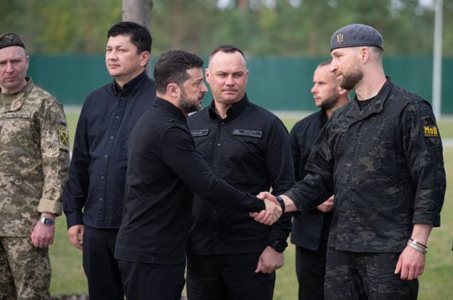 President of Ukraine Volodymyr Zelenskyy (L, front) shakes hands with Acting Minister of Defence of Ukraine Yevhenii Khmara in the presence of Commander-in-Chief of the Armed Forces of Ukraine Mykhailo Drapatyi, Minister for Veterans Affairs of Ukraine Vitalii Kim and Minister of Internal Affairs of Ukraine Ivan Vyhivskyi (L to R, back) during the solemn reburial ceremony of Colonel Yevhen Konovalets, first head of the Organisation of Ukrainian Nationalists (OUN) and colonel of the Army of the Ukrainian People’s Republic (UNR), at the National Military Memorial Cemetery in Kyiv region, Ukraine, August 18, 2026. On August 11, 2026, Konovalets’ remains were exhumed at Crooswijk General Cemetery in Rotterdam, the Netherlands, where they had re  Copyright: xDanyloxAntoniukx