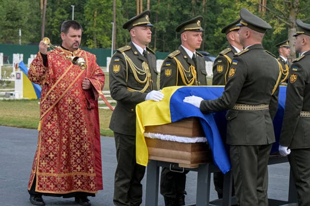 A priest walks with a thurible around the coffin of Colonel Yevhen Konovalets, first head of the Organisation of Ukrainian Nationalists (OUN) and colonel of the Army of the Ukrainian People’s Republic (UNR), during the solemn reburial ceremony at the National Military Memorial Cemetery in Kyiv region, Ukraine, August 18, 2026. On August 11, 2026, Konovalets’ remains were exhumed at Crooswijk General Cemetery in Rotterdam, the Netherlands, where they had rested since his assassination by a Soviet agent in May 1938. (Photo by Danylo Antoniuk Ukrinform) Remains of OUN leader Yevhen Konovalets reburied at National Military Memorial Cemetery  Copyright: xDanyloxAntoniukx