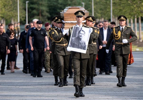 Remains of OUN leader Yevhen Konovalets reburied at National Military Memorial Cemetery Honour guards of the Ukrainian Armed Forces carry a portrait and the coffin with the remains of Colonel Yevhen Konovalets, first head of the Organisation of Ukrainian Nationalists (OUN) and colonel of the Army of the Ukrainian People™s Republic (UNR), during the solemn reburial ceremony at the National Military Memorial Cemetery in Kyiv region, Ukraine, August 18, 2026. On August 11, 2026, Konovalets™ remains were exhumed at Crooswijk General Cemetery in Rotterdam, the Netherlands, where they had rested since his assassination by a Soviet agent in May 1938., Credit:Danylo Antoniuk Ukrinform Avalon Ukraine, Kyiv region  Copyright: xDanyloxAntoniukx xUkrinformx xAvalonx 1125202313