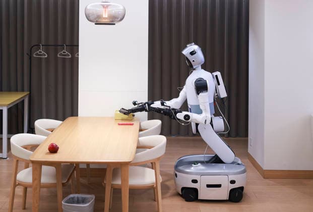 BEIJING, CHINA - AUGUST 18: A robot competitor arranges items on a table during the Household Scenario Event at the 2026 World Humanoid Robot Games on August 18, 2026 in Beijing, China. The 2026 World Humanoid Robot Games launched its first-ever Household Scenario Event in Beijing, featuring 38 robot teams competing in domestic tasks such as laundry and organization.  Copyright: xChinaxNewsxServicex 111660738967