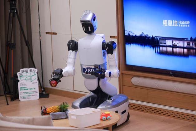 BEIJING, CHINA - AUGUST 18: A robot contestant picks up fruit to arrange a platter during the Household Scenario Competition of the 2026 World Humanoid Robot Games on August 18, 2026 in Beijing, China. This marks the first time the World Humanoid Robot Games has included a household scenario competition, with 38 robot teams competing in tasks such as laundry, drying clothes, and organizing storage.  Copyright: xChinaxNewsxServicex 111660739460