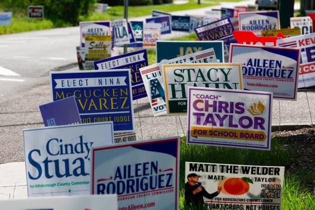 August 18, 2026, Tampa, Florida, USA: A large gathering of signs are displayed during primary day outside of the Port Tampa Center on Tuesday, Aug. 18, 2026, in Tampa. Tampa USA - ZUMAs70_ 20260818_zan_s70_061 Copyright: xJeffereexWoox