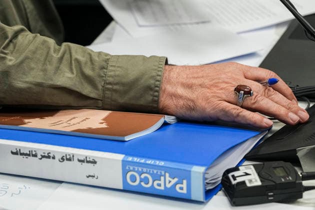 Tehran Iran Virtual Parliament Iranian Parliament Speaker Mohammad Bagher Ghalibaf s hand rests on parliamentary documents during a virtual session of Iran s parliament in Tehran, Iran on August 18, 2026. Iran s parliament held the public session remotely under emergency provisions, with 247 lawmakers participating. Tehran Tehran Iran Copyright: xHamedxMalekpourx