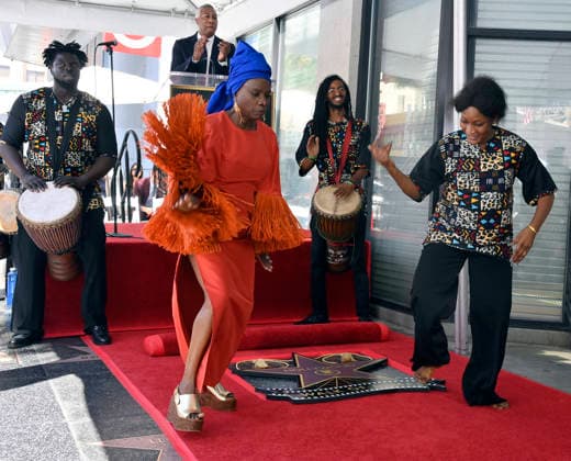 Five-time Grammy-winning Beninese musician, actress, and activist Angelique Kidjo dances with performers during an unveiling ceremony honoring her with the 2,854th star on the Hollywood Walk of Fame in Los Angeles on Tuesday, August 18, 2026.  LAP2026081804 JIMxRUYMEN