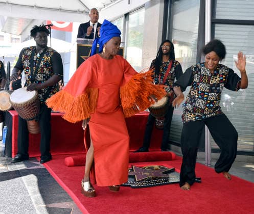 Five-time Grammy-winning Beninese musician, actress, and activist Angelique Kidjo dances with performers during an unveiling ceremony honoring her with the 2,854th star on the Hollywood Walk of Fame in Los Angeles on Tuesday, August 18, 2026.  LAP2026081805 JIMxRUYMEN