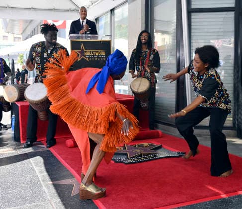 Five-time Grammy-winning Beninese musician, actress, and activist Angelique Kidjo dances with performers during an unveiling ceremony honoring her with the 2,854th star on the Hollywood Walk of Fame in Los Angeles on Tuesday, August 18, 2026.  LAP2026081807 JIMxRUYMEN
