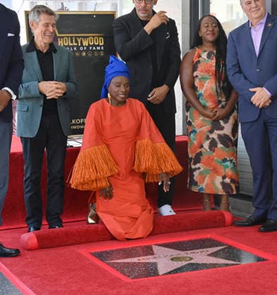 Five-time Grammy-winning Beninese musician, actress, and activist Angelique Kidjo reacts as actor Willem Dafoe (L) looks on during an unveiling ceremony honoring her with the 2,854th star on the Hollywood Walk of Fame in Los Angeles on Tuesday, August 18, 2026.  LAP2026081811 JIMxRUYMEN