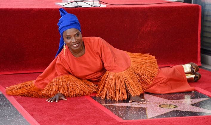 Five-time Grammy-winning Beninese musician, actress, and activist Angelique Kidjo lies beside her star during an unveiling ceremony honoring her with the 2,854th star on the Hollywood Walk of Fame in Los Angeles on Tuesday, August 18, 2026.  LAP2026081815 JIMxRUYMEN