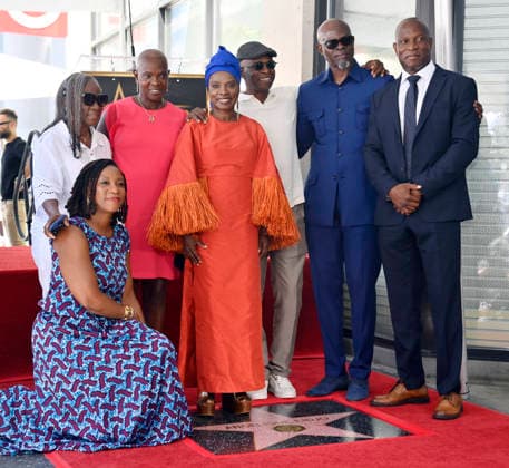 Five-time Grammy-winning Beninese musician, actress, and activist Angelique Kidjo is joined actor Djimon Hounsou (2-R) and other attendees during an unveiling ceremony honoring her with the 2,854th star on the Hollywood Walk of Fame in Los Angeles on Tuesday, August 18, 2026.  LAP2026081828 JIMxRUYMEN