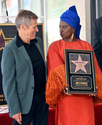 Five-time Grammy-winning Beninese musician, actress, and activist Angelique Kidjo holds a replica plaque as she is joined by actor Willem Dafoe (L) looks on during an unveiling ceremony honoring her with the 2,854th star on the Hollywood Walk of Fame in Los Angeles on Tuesday, August 18, 2026.  LAP2026081832 JIMxRUYMEN