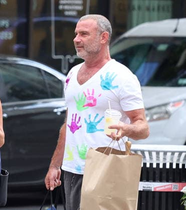 Liev Schreiber With His Wife Out in NYC Actor Liev Schreiber with a funny hand painted tshirt is walking with his wife Taylor Neisen in Soho, New York on August 18, 2026. Photo by Dylan Travis ABACAPRESS.COM New York City New York United States  Copyright: xDylanxTravis ABACAx