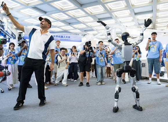 BEIJING, CHINA - AUGUST 19: A humanoid robot performs dance moves, attracting foreign spectators to take photos, during the opening of the 2026 World Robot Conference on August 19, 2026 in Beijing, China. The World Robot Conference 2026 kicks off in Beijing on August 19, bringing together leading robotics companies, experts and innovators from around the world. The event showcases the latest advances and applications across the robotics industry, from humanoid robots and embodied intelligence to cutting-edge components and real-world solutions.  Copyright: xChinaxNewsxServicex 111660848267