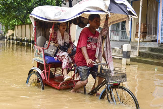 Heavy rainfall in India s Guwahati GUWAHATI, INDIA - AUGUST 19:A rickshaw driver is making his way along a flooded road with his passenger following heavy rainfall in Guwahati, Assam state, India, on August 19, 2026. The severe monsoon downpour triggered widespread flash flooding and waterlogging across multiple neighborhoods, disrupting normal life and forcing residents to use makeshift watercraft and boats for daily transportation. Hafiz Ahmed Anadolu Guwahati India. Editorial use only. Please get in touch for any other usage.  Copyright: x2026xAnadoluxHafizxAhmedx