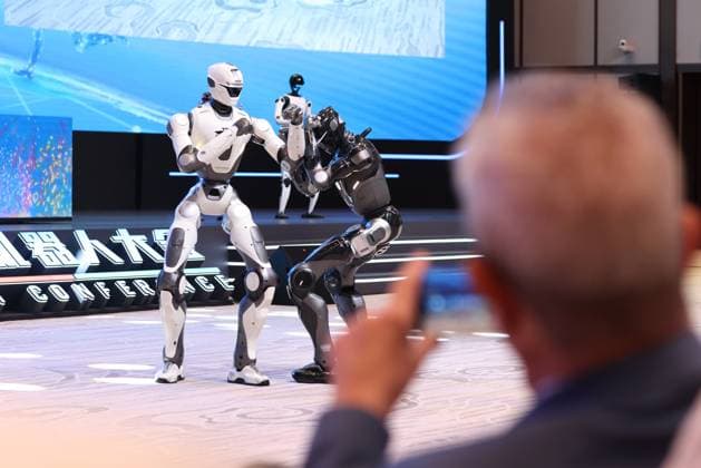 BEIJING, CHINA - AUGUST 19: Guests take photos of a robot performance during the opening of the 2026 World Robot Conference at the Beiren Etrong International Exhibition and Convention Center on August 19, 2026 in Beijing, China. The World Robot Conference (WRC) 2026 is set to run from 19-23 August, serving as both a sprawling playground for industrial titans and a high-minded academic symposium for the architects of our automated future.  Copyright: xChinaxNewsxServicex 111660852564