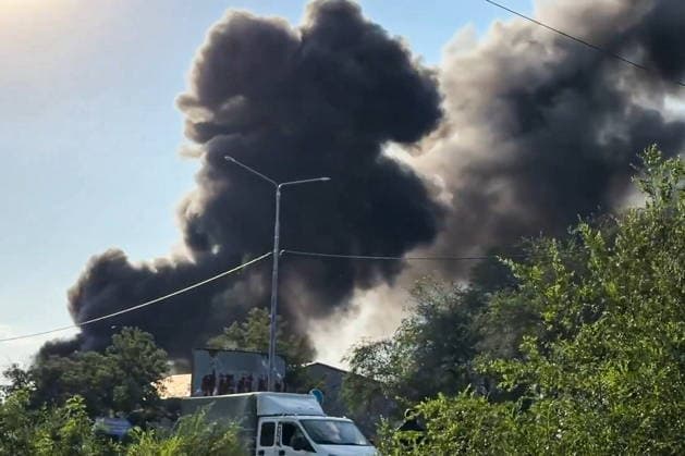 RUSSIA, LUGANSK - AUGUST 19, 2026: Smoke billows over a storage shed destroyed by a Ukrainian military strike, with a car repair shop and a confectionery factory inside. Video screen grab. Best quality available. Danil Derkayev TASS  96343853