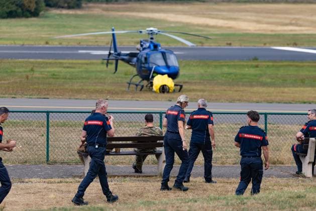 Firemen pictured on the Spa airfield near the site of the fire in the Hautes Fagnes (High Fens) nature reserve, on Wednesday 19 August 2026. The fire started on August 14th and 3000 hectares (on a total of 4500) are impacted.  BRUNOxFAHY 183772069
