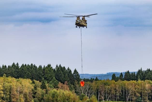 Chinook helicopter pictured on the Spa airfield near the site of the fire in the Hautes Fagnes (High Fens) nature reserve, on Wednesday 19 August 2026. The fire started on August 14th and 3000 hectares (on a total of 4500) are impacted.  BRUNOxFAHY 183773383