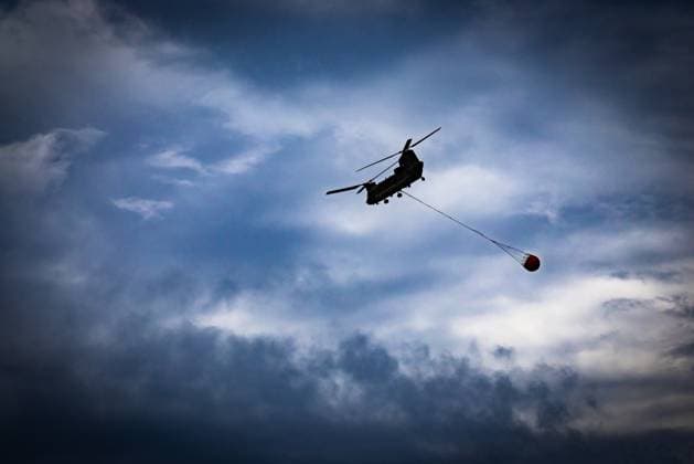 Chinook helicopter pictured on the site of the fire in the Hautes Fagnes (High Fens) nature reserve, on Wednesday 19 August 2026. The fire started on August 14th and 3000 hectares (on a total of 4500) are impacted.  BRUNOxFAHY 183773932