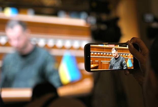 A journalist captures a speech by recently appointed Ukrainian Minister of Defence Yevhenii Khmara with a smartphone during a sitting of the Verkhovna Rada, broadcast for the media at the press centre of the Ukrainian Parliament, Kyiv, Ukraine, August 19, 2026. The Verkhovna Rada approved President Volodymyr Zelenskyy’s nomination of Khmara as Defence Minister, with 312 lawmakers voting in favour. Khmara, a Major General of the Security Service of Ukraine (SSU) and special operations officer, served for more than 15 years in the SSU’s Special Operations Centre A (Alpha). During the full-scale war, he took part in combat operations, including the liberation of Kyiv region, fighting in Donetsk region, and the operation to liberate Zmiinyi (Sn  Copyright: xYevhenxKotenkox