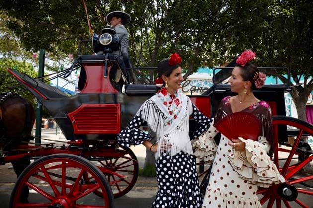 Scenes from the Málaga Fair: Several women dressed in flamenco outfits stroll through the Málaga Fair on August 19, 2026, in Málaga, Andalusia, Spain As they do every year, locals and visitors enjoy the Málaga Fair at the fairgrounds August 19, 2026, in Málaga, Andalusia, Málaga, Andalusia, Spain  Copyright: xÃlexxZeax 7721030