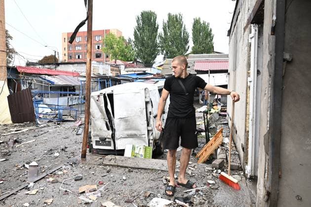 A man removes the rubble at the central market, damaged by a Russian attack, Zaporizhzhia, Ukraine, August 19, 2026. Overnight, the Russian army struck the south-eastern Ukrainian city with drones, destroying a hostel, a shopping centre, and the central market. (Photo by Dmytro Smolienko Ukrinform) Russian drones attack central market in Zaporizhzhia  Copyright: xDmytroxSmolienkox