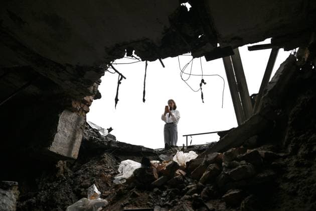 A woman takes a picture with a smartphone of a warehouse at the central market, damaged by a Russian attack, Zaporizhzhia, Ukraine, August 19, 2026. Overnight, the Russian army struck the south-eastern Ukrainian city with drones, destroying a hostel, a shopping centre, and the central market. (Photo by Dmytro Smolienko Ukrinform) Russian drones attack central market in Zaporizhzhia  Copyright: xDmytroxSmolienkox