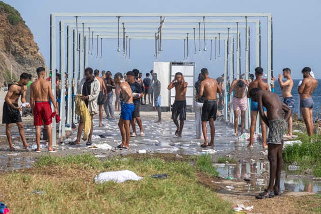 The humanitarian crisis in Ceuta continues. Several migrants shower on Trampolín Beach on August 19, 2026, in Ceuta, Spain. Ceuta continues to face a serious humanitarian crisis following the historic mass influx of more than 70,000 migrants who swam across the Tarajal on July 30 and 31. Although the current police deployment and border reinforcement by by Moroccan authorities have succeeded in curbing the influx, the autonomous city continues to face a serious humanitarian crisis, health, and security crises. AUGUST 19, 2026 CEUTA MIGRATION CRISIS MIGRANTS IMMIGRANTS SPRINGBOARD TARAJAL PIXELATED Ceuta Ceuta, Spain  Copyright: xMarcosxMorenox 7721163