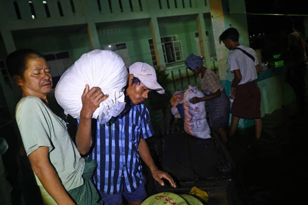 August 19, 2026, Ngathaingchaung, Ayeyarwady Division, Myanmar: Evacuees transport supplies by boat at night to a flood relief camp in Ngathaingchaung Township, Ayeyarwady Region..In Laymyethna Township, Ayeyarwady Region, the Ngawun River embankment collapsed on July 31, leaving nearby towns including Hinthada, Yegyi, Ngathaingchaung, Kyonpyaw and Kyaunggon still inundated, affecting tens of thousands of people, officials said. Ngathaingchaung Myanmar  - ZUMAn324 20260819_zip_n324_025 Copyright: xAyexMyaxNaingx