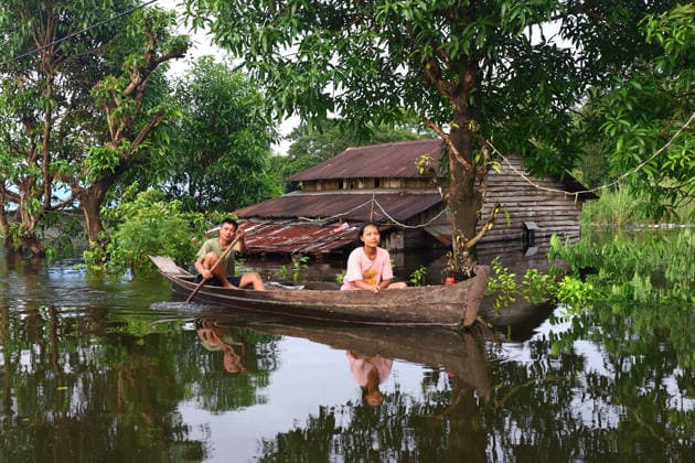 August 19, 2026, Ngathaingchaung, Ayeyarwady Division, Myanmar: People travel by boats through floodwaters in Ngathaingchaung Township, Ayeyarwady Region..In Laymyethna Township, Ayeyarwady Region, the Ngawun River embankment collapsed on July 31, leaving nearby towns including Hinthada, Yegyi, Ngathaingchaung, Kyonpyaw and Kyaunggon still inundated, affecting tens of thousands of people, officials said. Ngathaingchaung Myanmar - ZUMAn324 20260819_zip_n324_054 Copyright: xAyexMyaxNaingx