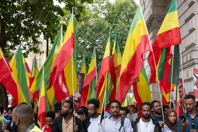 Amhara Protesters Block Downing Street Entrance in London - 19 Aug 2026 Demonstrators carrying Ethiopian flags march through central London. Members of the Amhara community held a protest against what they describe as an ongoing campaign of ethnic cleansing and genocide against the Amhara people by the Ethiopian government. The Amhara are one of Ethiopia s largest ethnic groups. Since armed conflict escalated between government forces and the Fano militia in the Amhara region in April 2023, rights groups and Amhara diaspora organisations have accused Prime Minister Abiy Ahmed s government of mass killings, displacement and drone strikes against Amhara civilians, allegations the Ethiopian government denies. The conflict has prompted repeated Copyright: xIanxDavidsonx xSOPAxImagesx idavidson32578