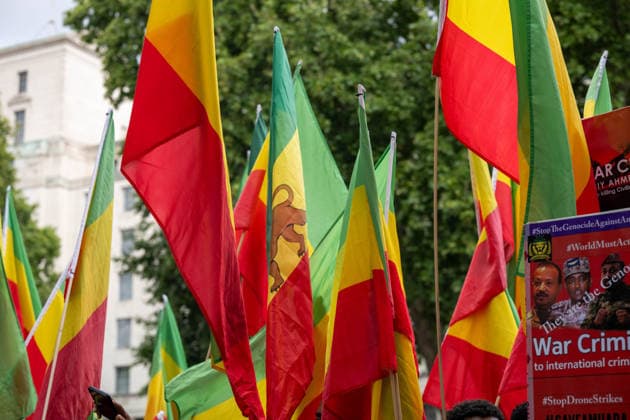 Amhara Protesters Block Downing Street Entrance in London - 19 Aug 2026 Ethiopian flags, one bearing the Lion of Judah emblem, are held above a placard reading War Criminals to International Crim inal Court and StopDroneStrikes during a march through central London. Members of the Amhara community held a protest against what they describe as an ongoing campaign of ethnic cleansing and genocide against the Amhara people by the Ethiopian government. The Amhara are one of Ethiopia s largest ethnic groups. Since armed conflict escalated between government forces and the Fano militia in the Amhara region in April 2023, rights groups and Amhara diaspora organisations have accused Prime Minister Abiy Ahmed s government of mass killings, displa Copyright: xIanxDavidsonx xSOPAxImagesx idavidson32591