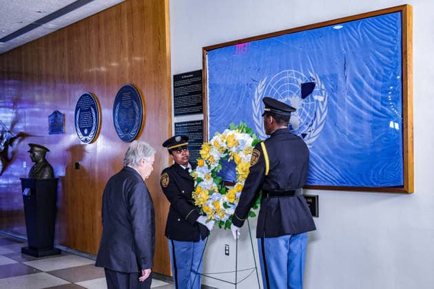 August 19, 2026, New York, New York, United States: United Nations Security Officers move a memorial wreath towards the original UN flag from the Canal Hotel in Baghdad as Secretary-General ANTONIO GUTERRES stands with his head bowed during an observance of World Humanitarian Day and the anniversary of the 19 August 2003 bombing of the UN headquarters in Baghdad, Iraq. New York United States - ZUMAo116 20260819_znp_o116_003 Copyright: xBiancaxOterox