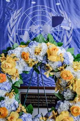 August 19, 2026, New York, New York, United States: A memorial wreath stands before the original UN flag from the Canal Hotel in Baghdad during an observance of World Humanitarian Day at UNHQ. The flag bears holes and tears sustained during the 19 August 2003 bombing of the UN headquarters in Baghdad, Iraq, which killed 22 people and injured more than 150 others. New York United States - ZUMAo116 20260819_znp_o116_009 Copyright: xBiancaxOterox