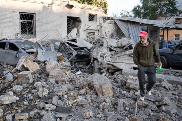 Ukraine says 12 people killed, 33 injured in Russia s overnight strike on Kyiv KYIV, UKRAINE - AUGUST 20: A man walks past damaged vehicles and debris following an overnight Russian attack on Kyiv, Ukraine, on August 20, 2026. Based on preliminary information provided by Kyiv Mayor Vitali Klitschko, at least 12 people were killed and 33 others wounded, while the Darnytskyi, Sviatoshynskyi and Solomianskyi districts sustained damage. Stringer Anadolu Kyiv Ukraine. Editorial use only. Please get in touch for any other usage.  Copyright: x2026xAnadoluxStringerx