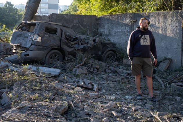 Ukraine says 12 people killed, 33 injured in Russia s overnight strike on Kyiv KYIV, UKRAINE - AUGUST 20: A man stands near a damaged vehicle and debris following an overnight Russian attack on Kyiv, Ukraine, on August 20, 2026. Based on preliminary information provided by Kyiv Mayor Vitali Klitschko, at least 12 people were killed and 33 others wounded, while the Darnytskyi, Sviatoshynskyi and Solomianskyi districts sustained damage. Stringer Anadolu Kyiv Ukraine. Editorial use only. Please get in touch for any other usage.  Copyright: x2026xAnadoluxStringerx