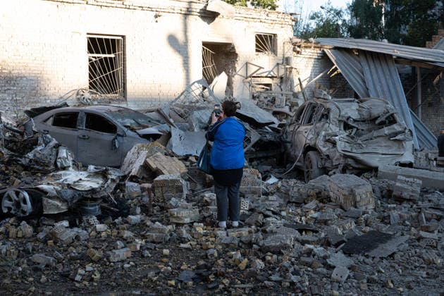 Ukraine says 12 people killed, 33 injured in Russia s overnight strike on Kyiv KYIV, UKRAINE - AUGUST 20: A woman takes a photo of damaged vehicles and debris following an overnight Russian attack on Kyiv, Ukraine, on August 20, 2026. Based on preliminary information provided by Kyiv Mayor Vitali Klitschko, at least 12 people were killed and 33 others wounded, while the Darnytskyi, Sviatoshynskyi and Solomianskyi districts sustained damage. Stringer Anadolu Kyiv Ukraine. Editorial use only. Please get in touch for any other usage.  Copyright: x2026xAnadoluxStringerx