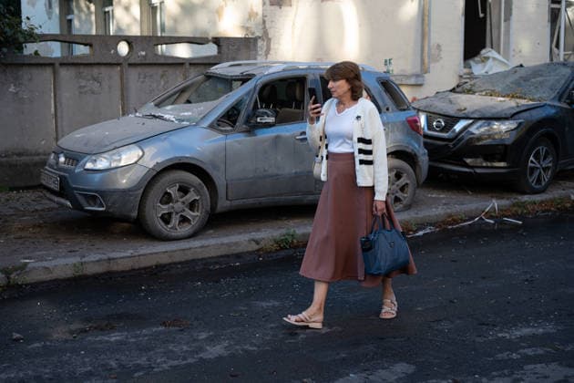 Ukraine says 12 people killed, 33 injured in Russia s overnight strike on Kyiv KYIV, UKRAINE - AUGUST 20: A woman walks past vehicles with shattered windows following an overnight Russian attack on Kyiv, Ukraine, on August 20, 2026. Based on preliminary information provided by Kyiv Mayor Vitali Klitschko, at least 12 people were killed and 33 others wounded, while the Darnytskyi, Sviatoshynskyi and Solomianskyi districts sustained damage. Stringer Anadolu Kyiv Ukraine. Editorial use only. Please get in touch for any other usage.  Copyright: x2026xAnadoluxStringerx